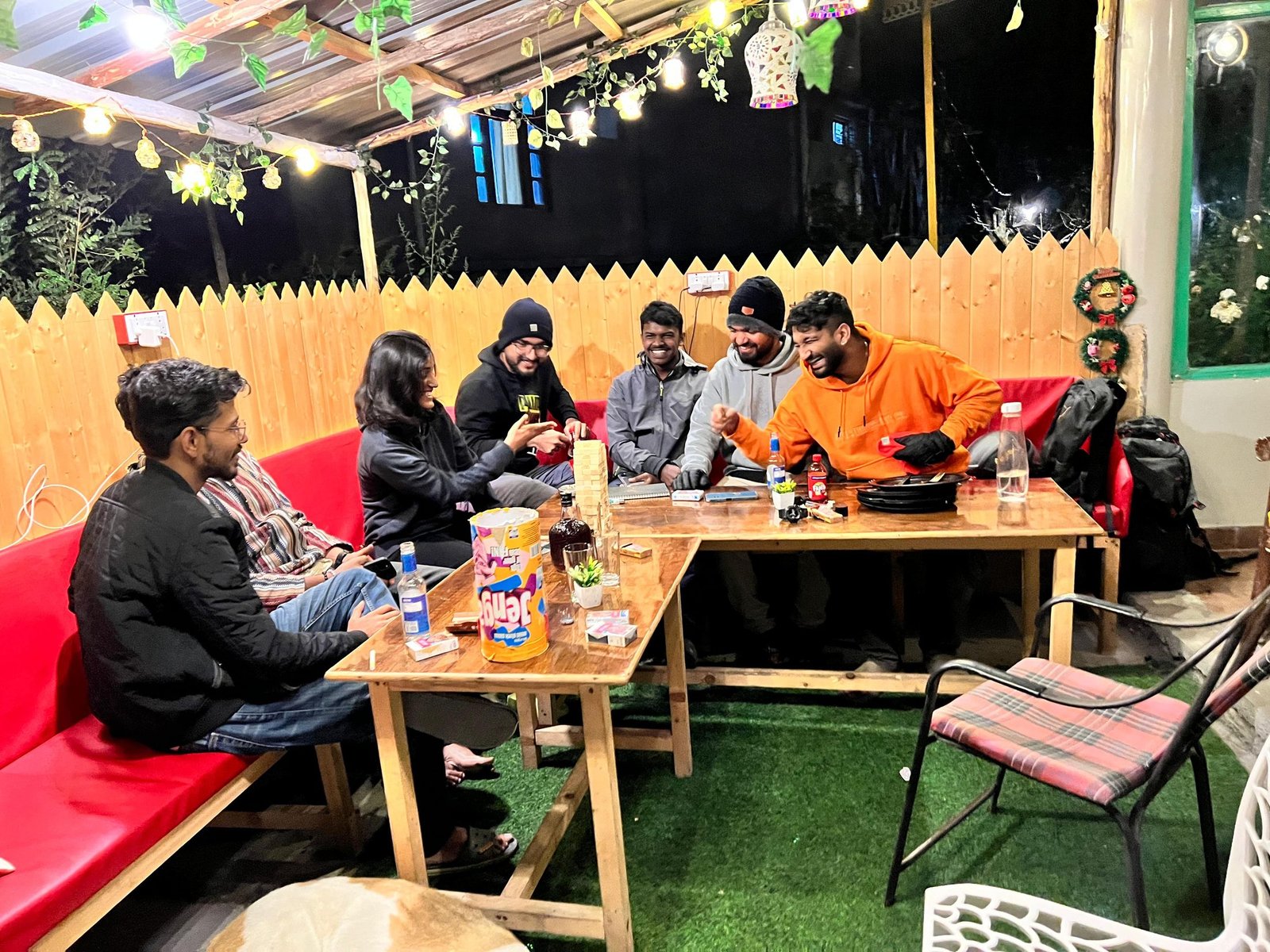 Guests playing board games around café tables at Safar Hostel